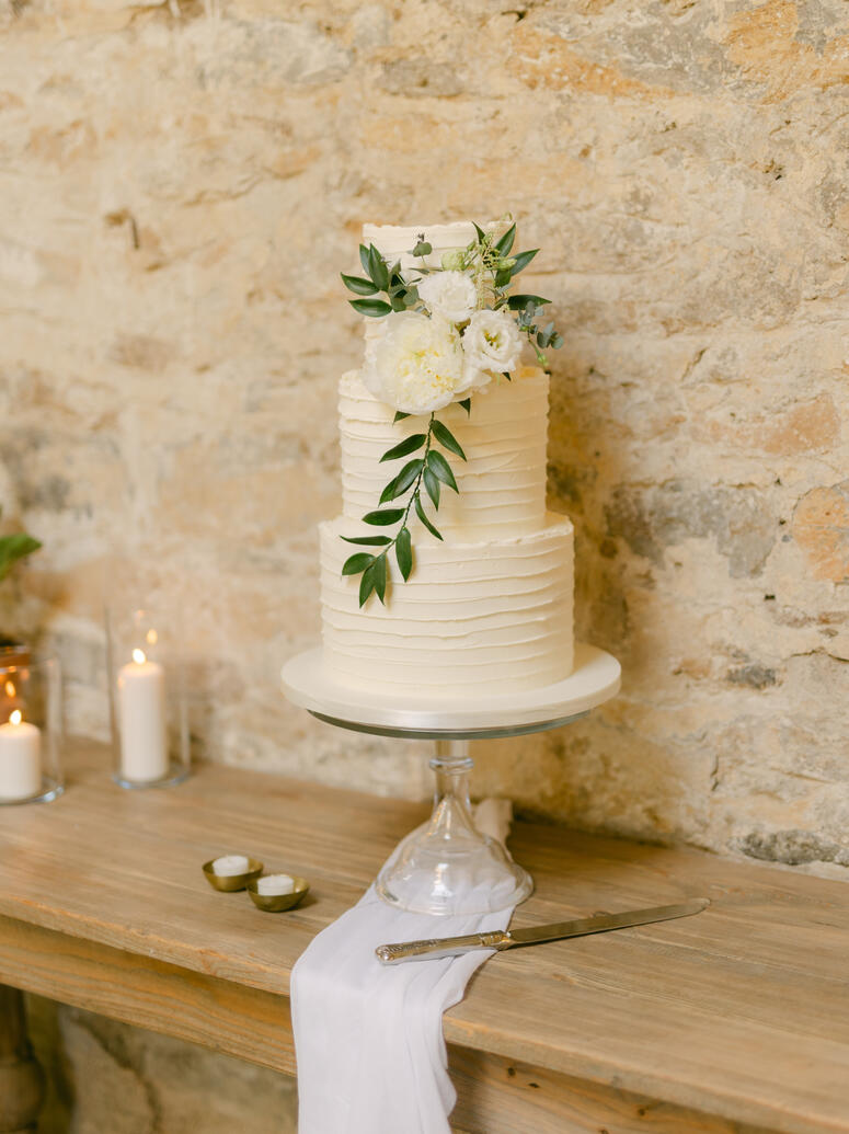 Buttercream wedding cake styled with fabric and candles Buttercream wedding cake styled with fabric and candles